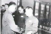 1955年9月27日，周恩来在北京为粟裕等颁发授予中国人民解放军大将军衔的命令状，图握手者为粟裕大将，右边为黄克诚大将。