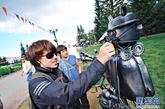 8月29日，在俄罗斯叶卡捷琳堡市中央公园举行的第三届叶卡捷琳堡国际“洛姆”雕塑艺术节上，游客对雕塑“仔细研究”。新华社发（安东 摄）图片来源：新华网