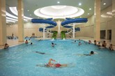 
学生在金日成大学游泳池里游泳玩耍，注意那俩滑水道。